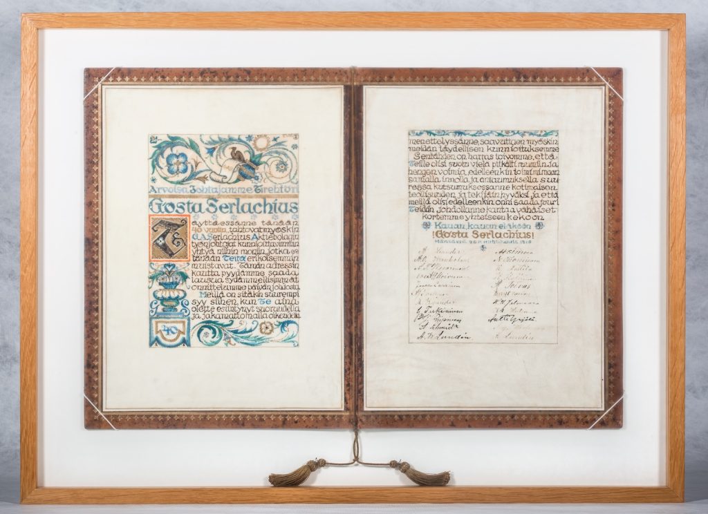 Kuvassa kehystetty koristeellinen adressi.